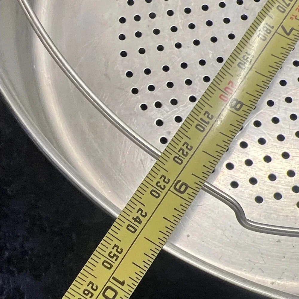 Stainless Steel Steamer Basket 9.5”. Has feet to sit above water to steam.
